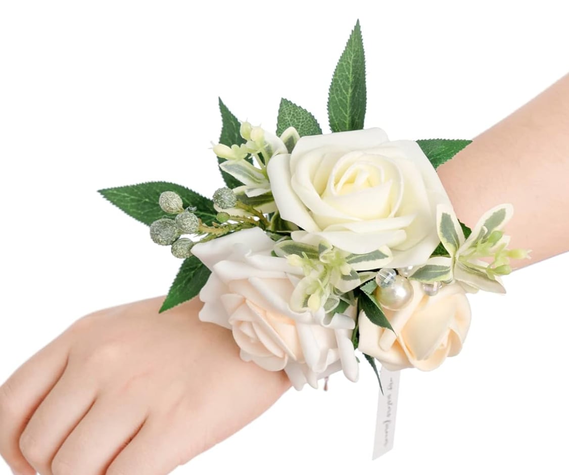 White and blush rose wrist corsage with green leaves and pearl accents