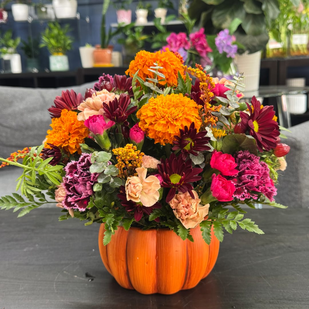 Colorful mixed bouquet in a pumpkin-shaped orange container