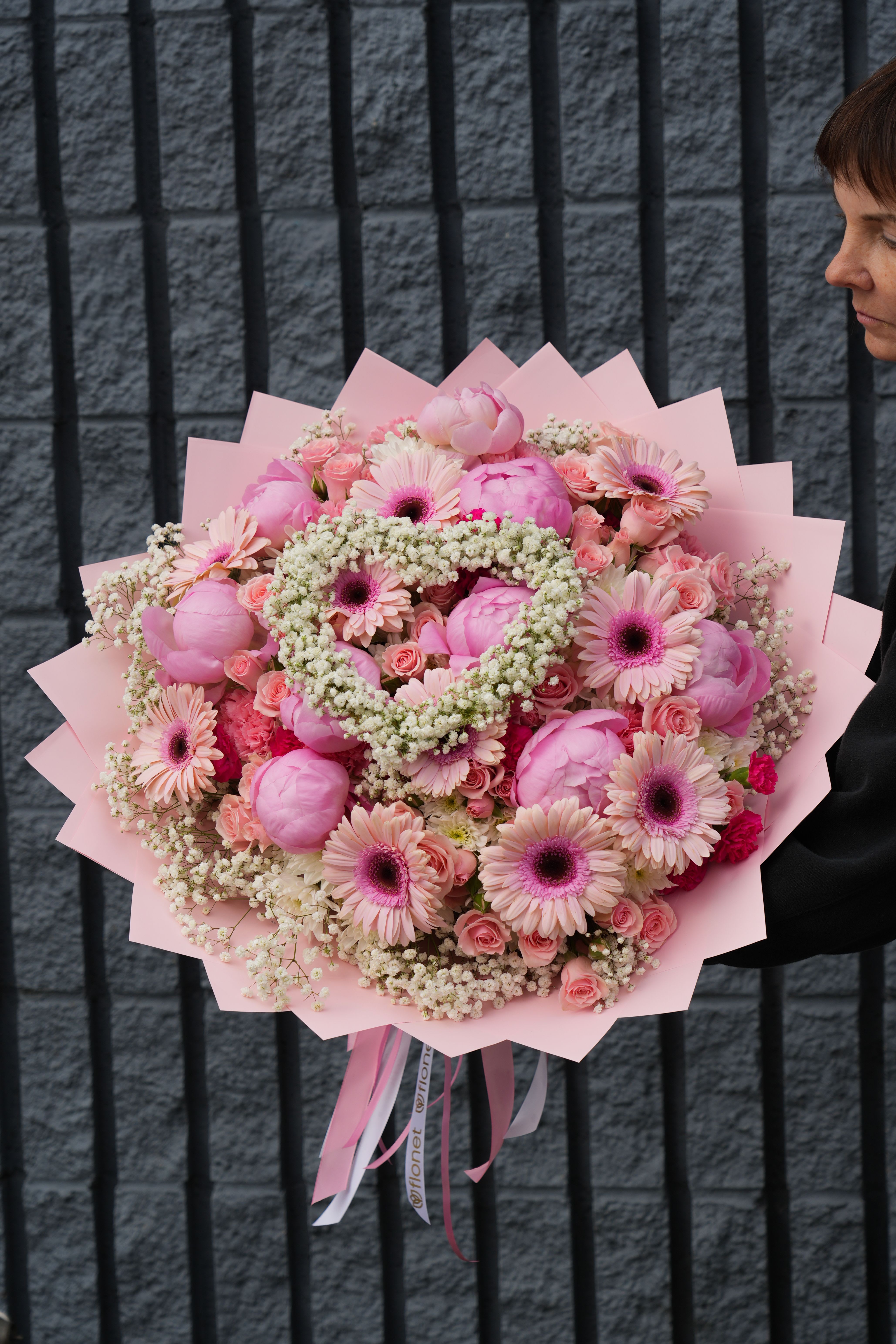 Large pink bouquet with gerbera daisies and roses wrapped in pink paper