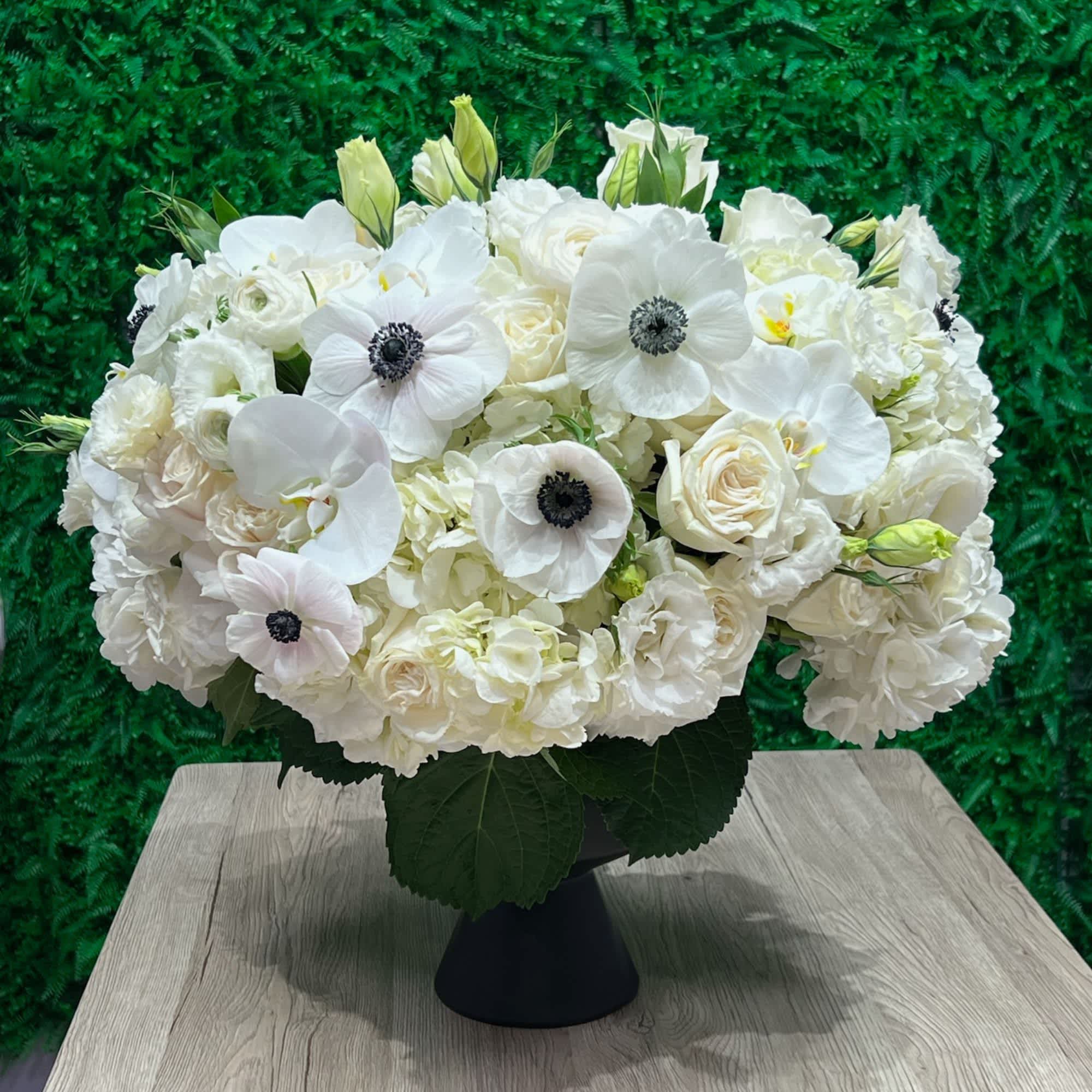 White Elegance in a black vase  - Hydrangea, Anemones, Roses, Lisianthus and Orchids 