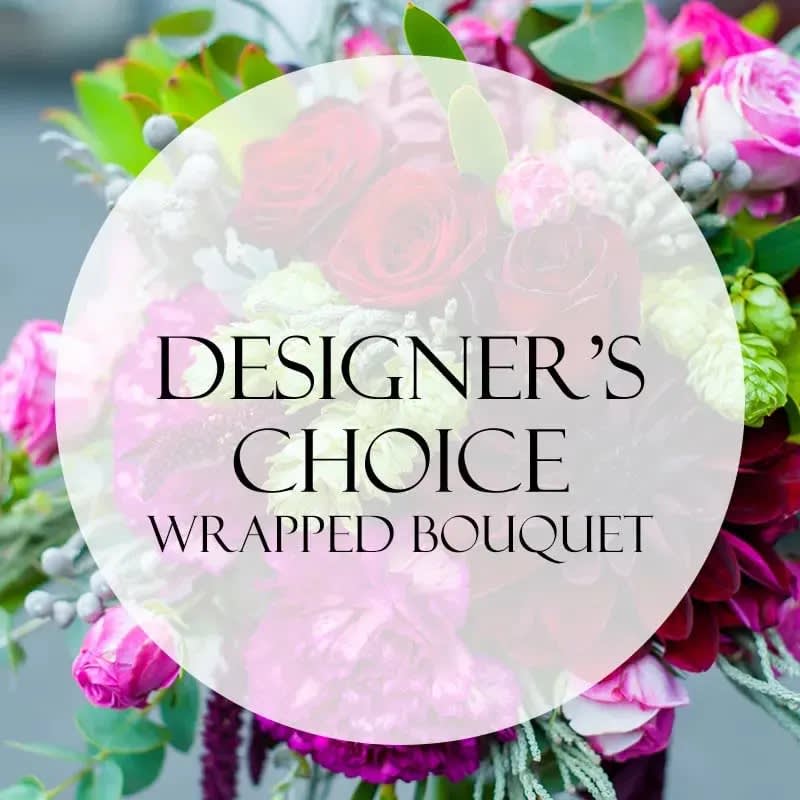 Wrapped bouquet of pink and white flowers with greenery