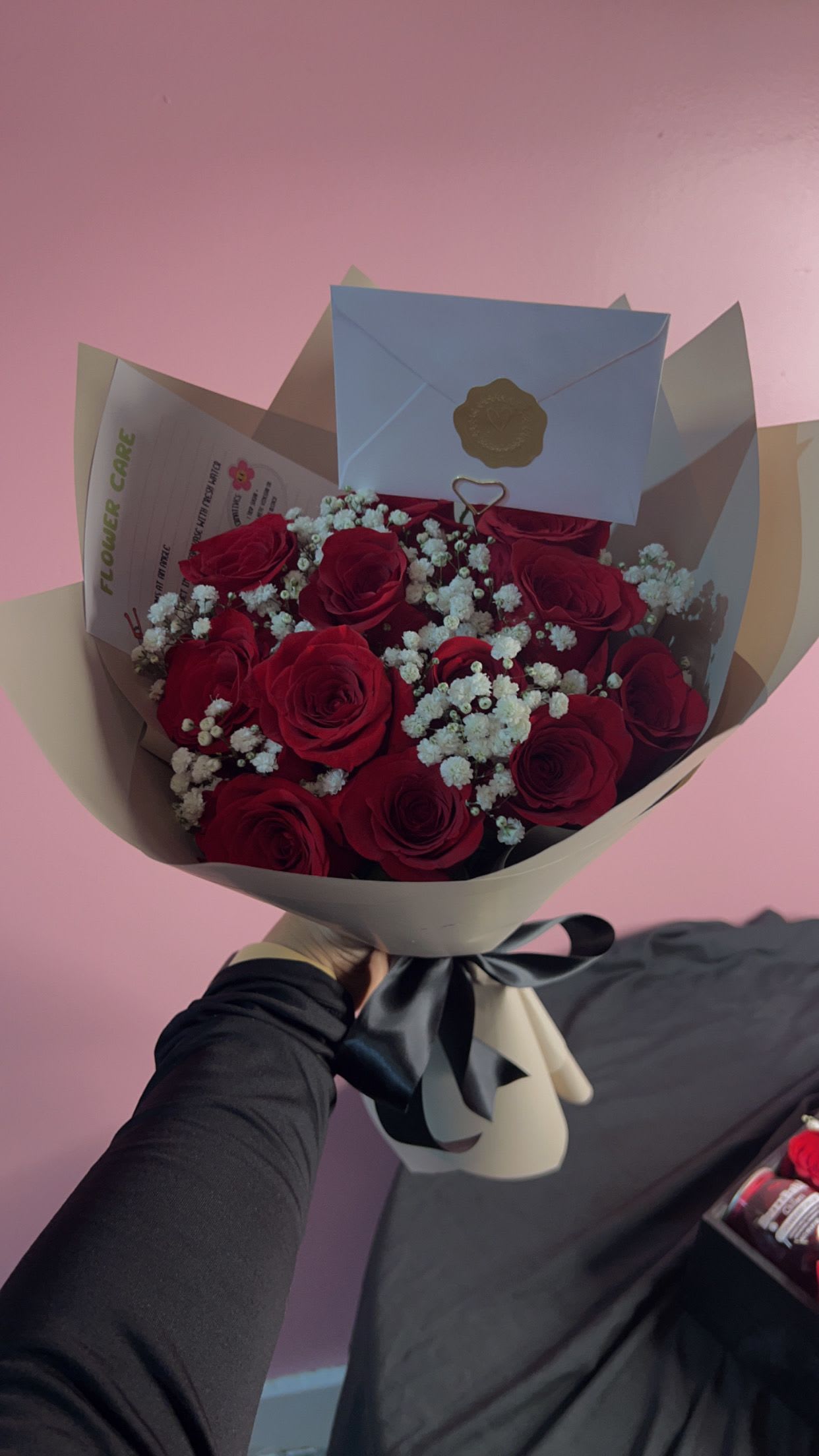 Bouquet of red roses with white baby's breath in beige and blue wrap