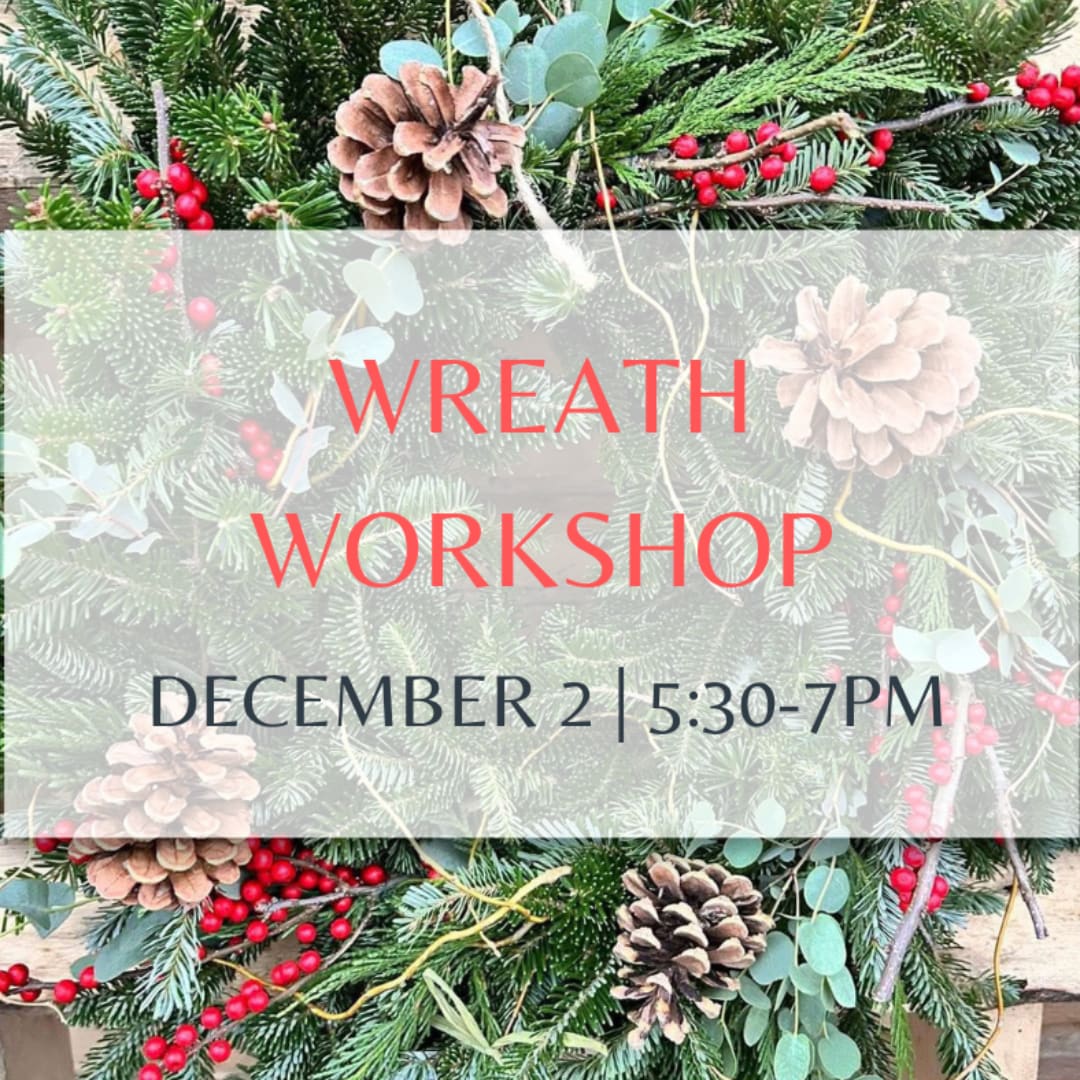 Holiday wreath with pinecones, red berries, and evergreen branches