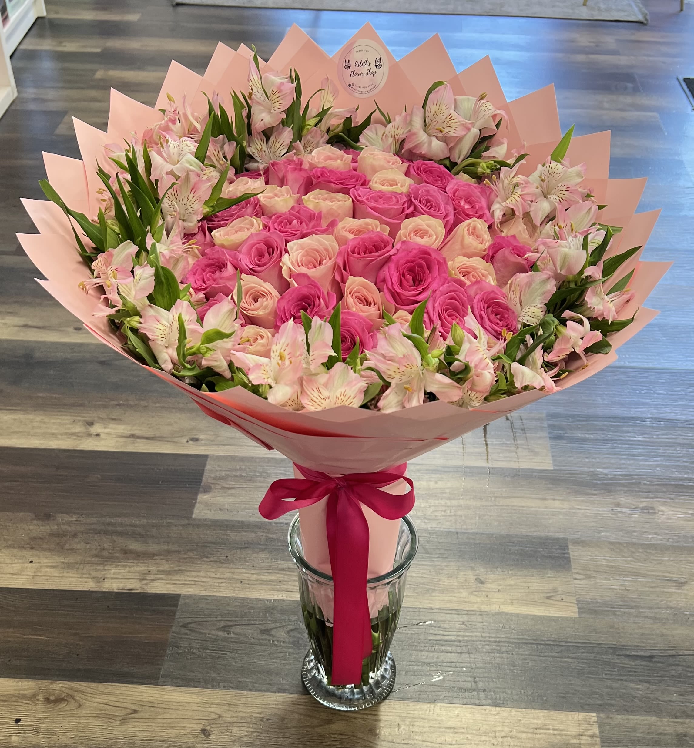 Pink rose bouquet with alstroemeria in pink wrap and ribbon