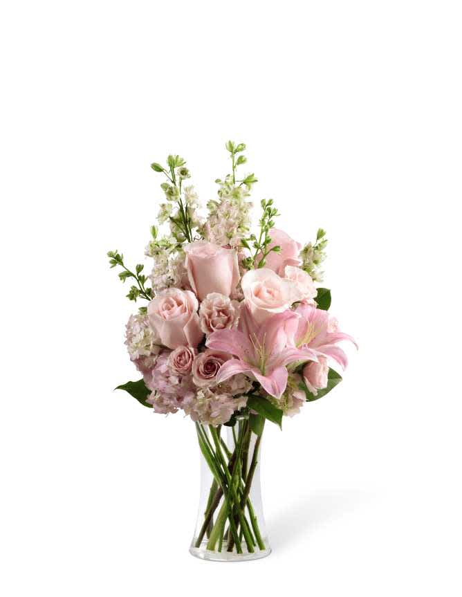 The FTD Wishes &amp; Blessings Bouquet - The FTD Wishes &amp; Blessings Bouquet is a stunning way to offer your condolences for their loss and commemorate the life of the deceased. Soft pink roses, spray roses, Oriental lilies, hydrangea and larkspur are brought together in a clear glass vase to create an eye-catching display of soft serenity.