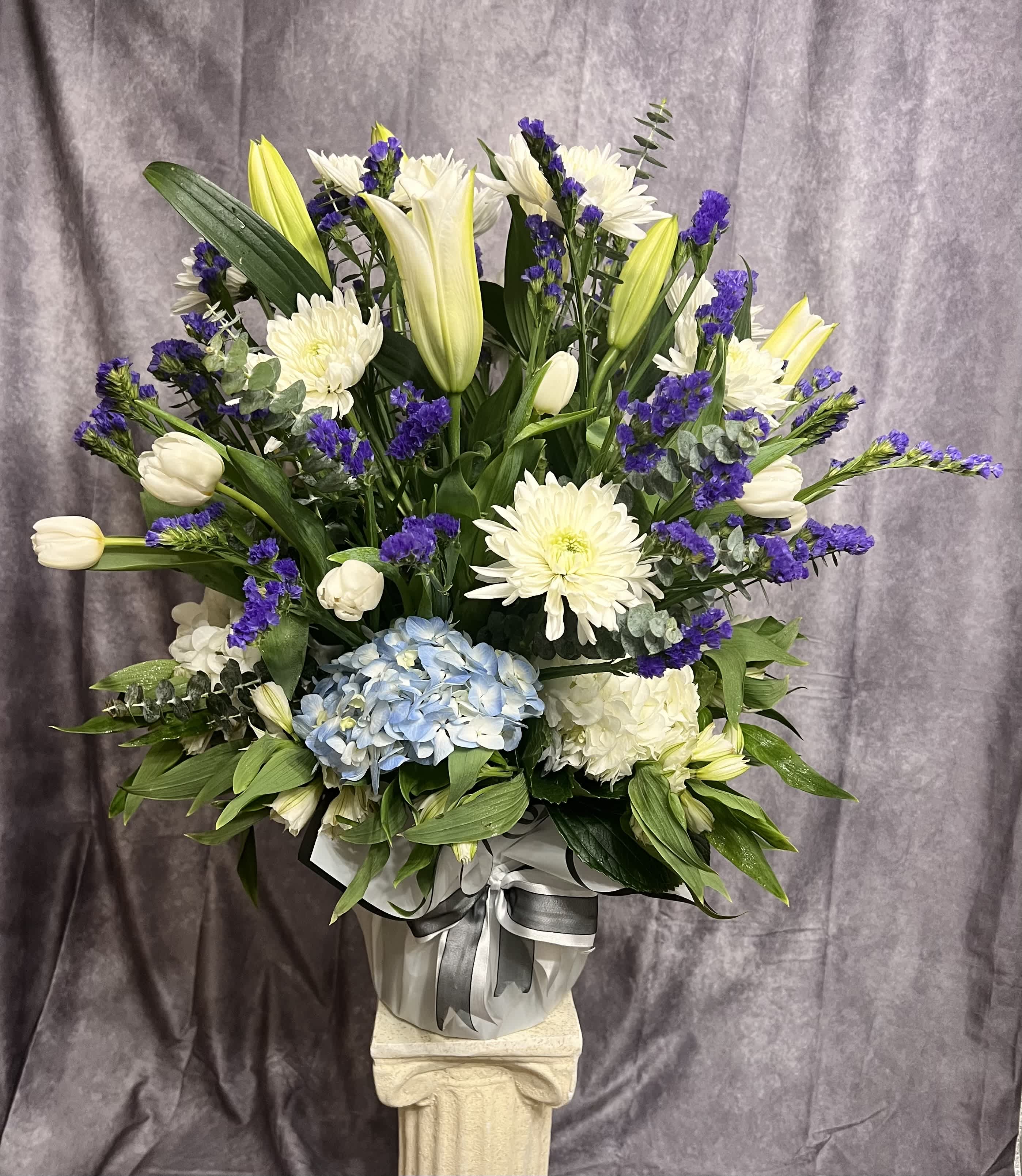 Deepest sympathy  - White and blue arrangements for the thought up above the clouds and sky. 
