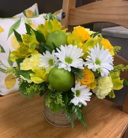 Summertime Lemonade - This bright bouquet is perfect for your summertime event! Fresh white Daisies, pale green Hydrangea, and yellow Roses, Carnations, Alstroemeria and Solidago, along with faux Limes make up a sunny arrangement for you to share. 