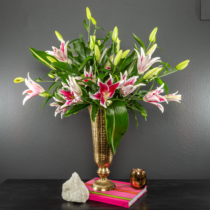 I am a Stargazer - 10 stems of stunning gazer lilies, SO gorgeous and fragrant. We get our lilies from a local grower, even in the winter! This locally grown flower delivery will impress even the classiest recipient.   This whole arrangement is approx 2-3 feet tall in a gorgeous gold vase. 