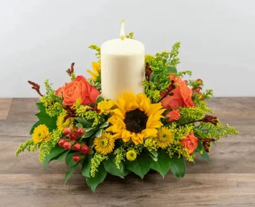 Lets Give Thanks - Illuminating centerpiece with Sunflowers and Roses with seasonal Poms. 