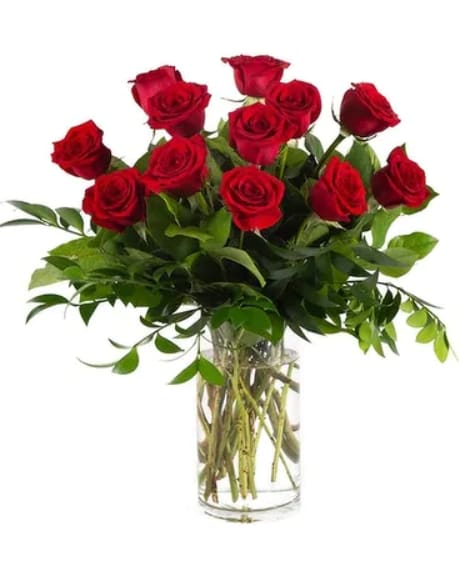 Red roses arranged in a clear glass vase