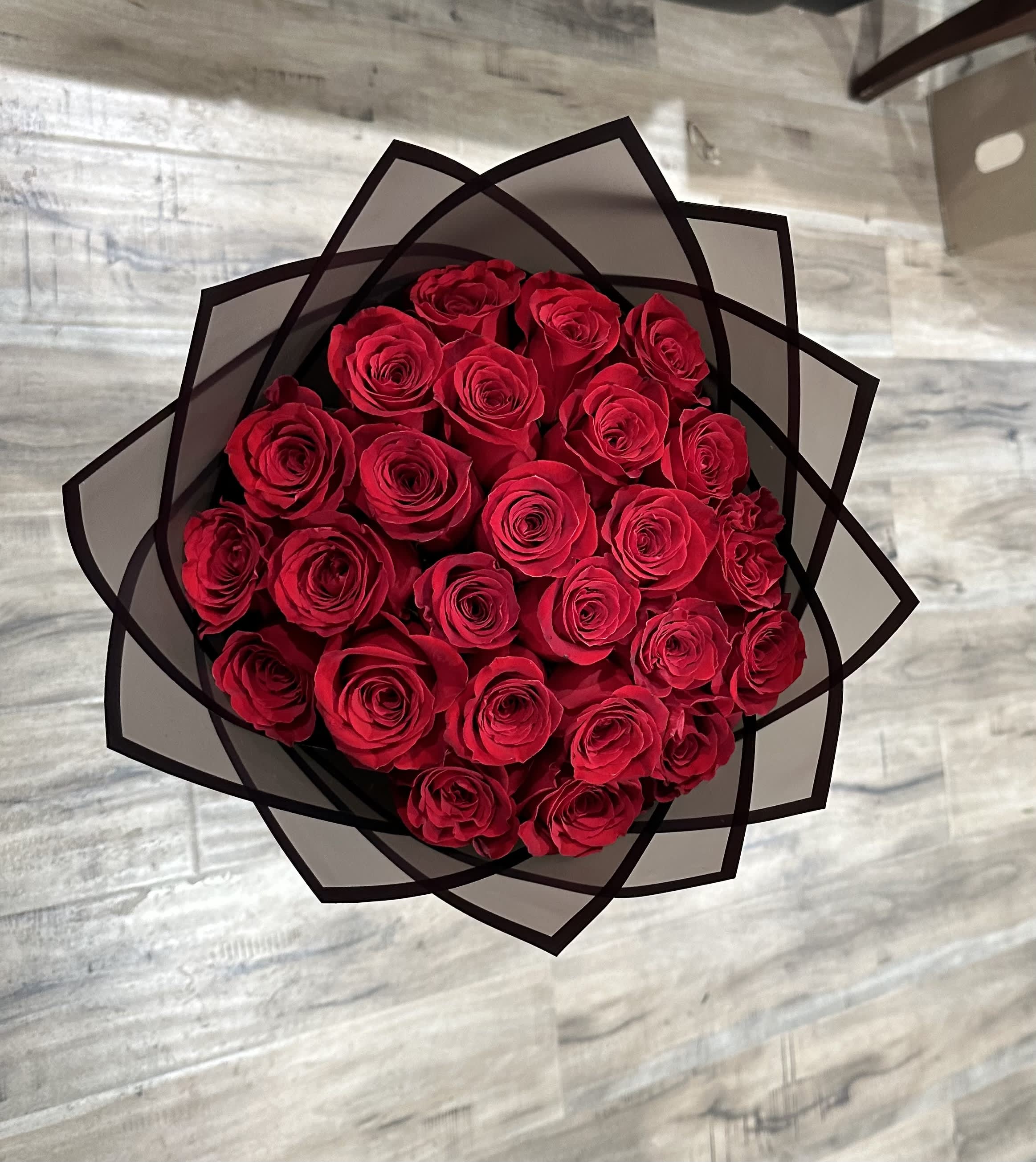 Bouquet of red roses wrapped in black paper