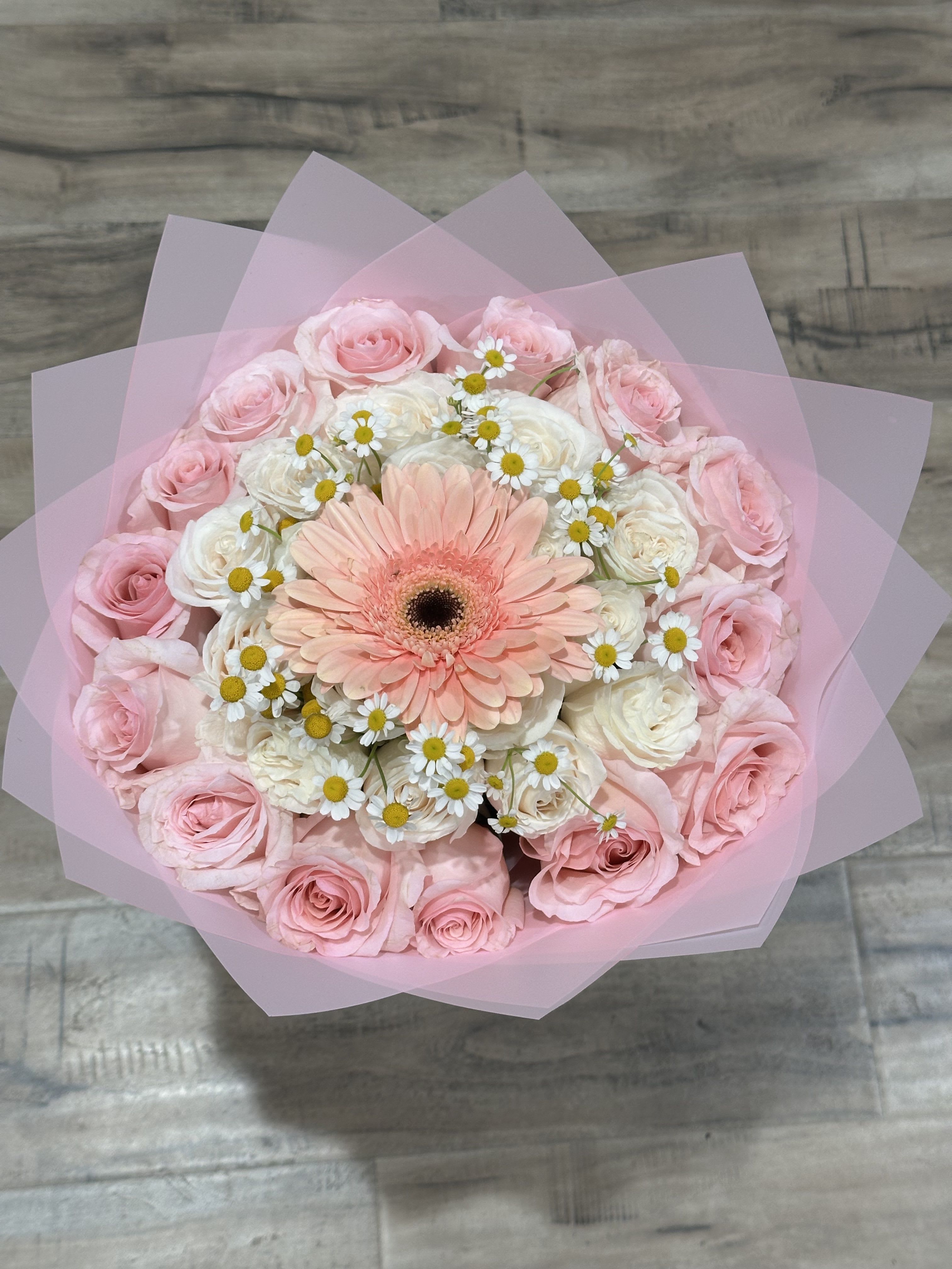 Pink and white bouquet with a peach gerbera daisy in pink wrap