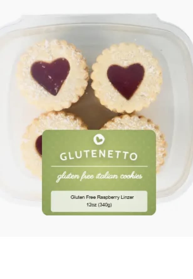 Container of heart-shaped raspberry linzer cookies