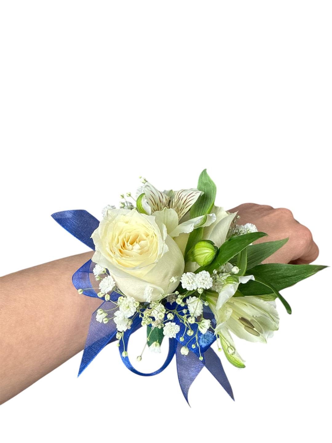 White rose wrist corsage with blue ribbon and small white flowers