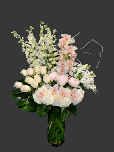 Tall bouquet of white and pale pink flowers in a glass vase