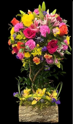 Tall mixed flower arrangement in a rectangular bark-textured container