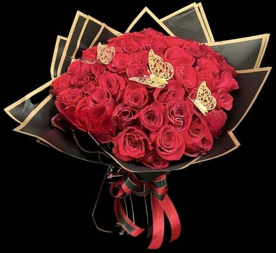 Bouquet of red roses wrapped in black paper with gold trim