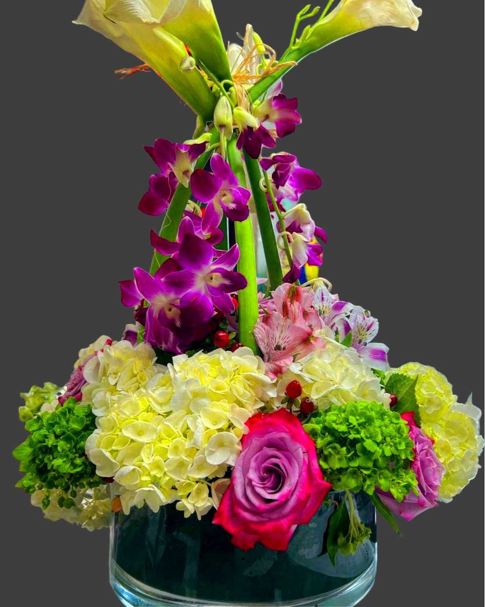 Large crown centerpiece mixed pastel colors - Very unique nice and beautiful large crown centerpiece with purple dendrobium orchids, pink and white alstroemeria, purple and lavender roses, white and green hydrangeas, white calla lilies designed in a large low 12 inch cylinder vase. 