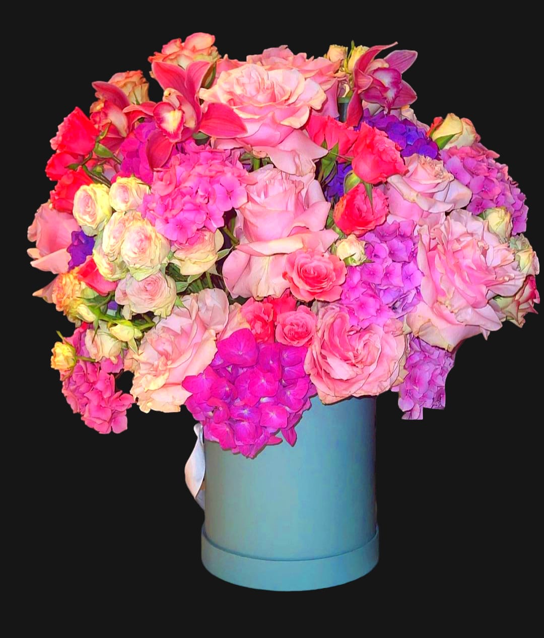Large bouquet of pink and purple flowers in a blue hatbox