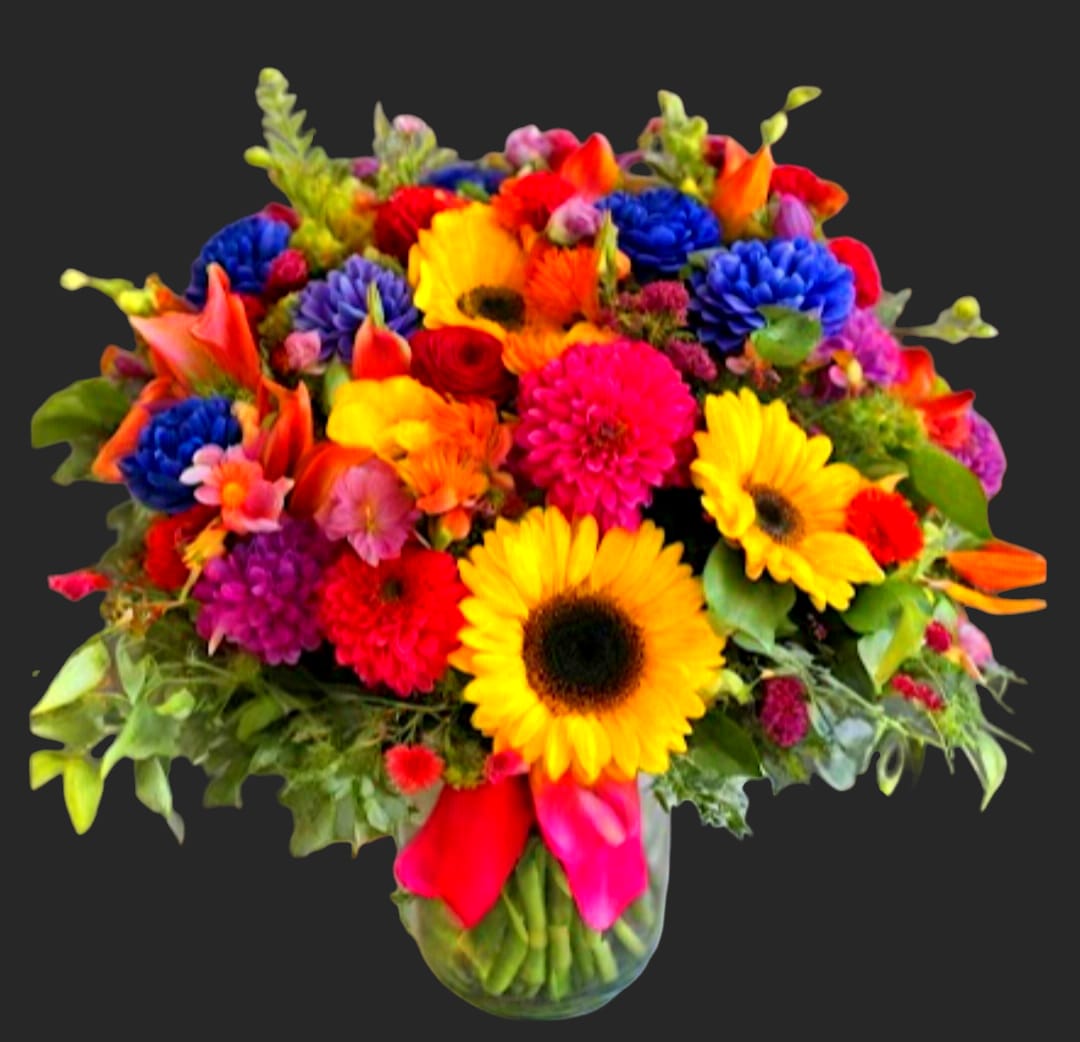Bright mixed bouquet with sunflowers, gerbera daisies, and calla lilies in a glass vase