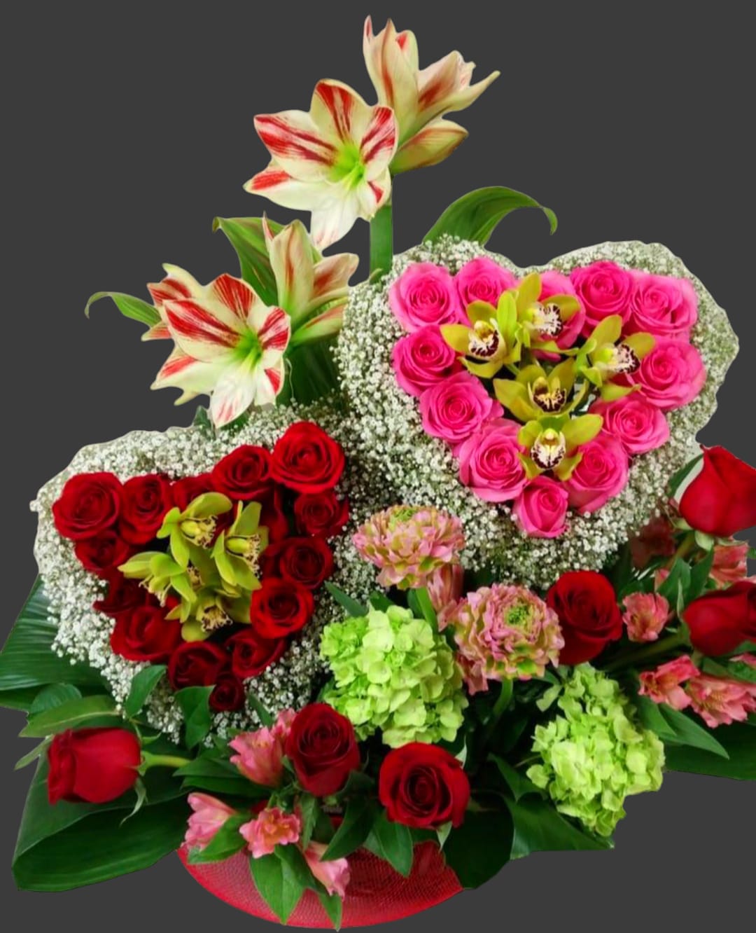 Heart-shaped bouquet of red and pink roses with white orchids and lilies