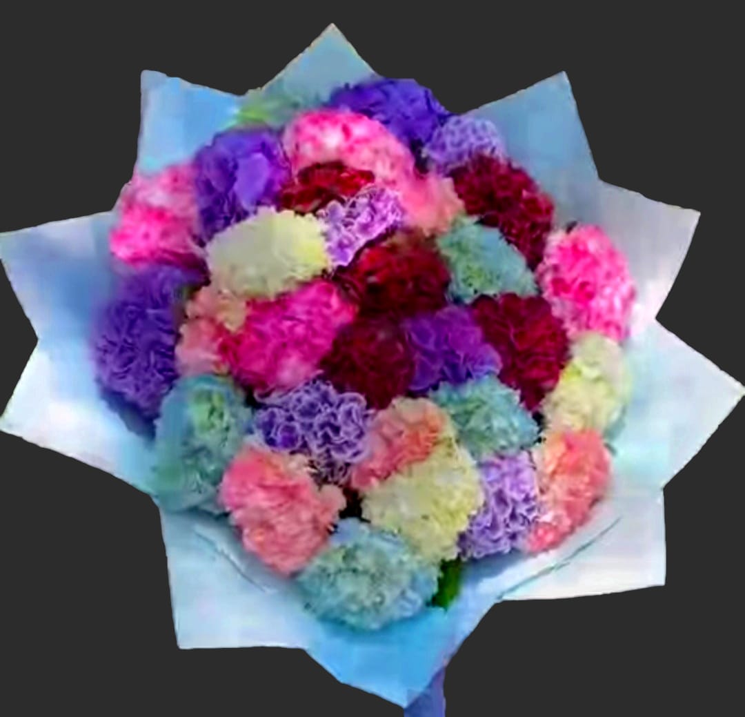 Bouquet of multicolored carnations wrapped in pale blue paper