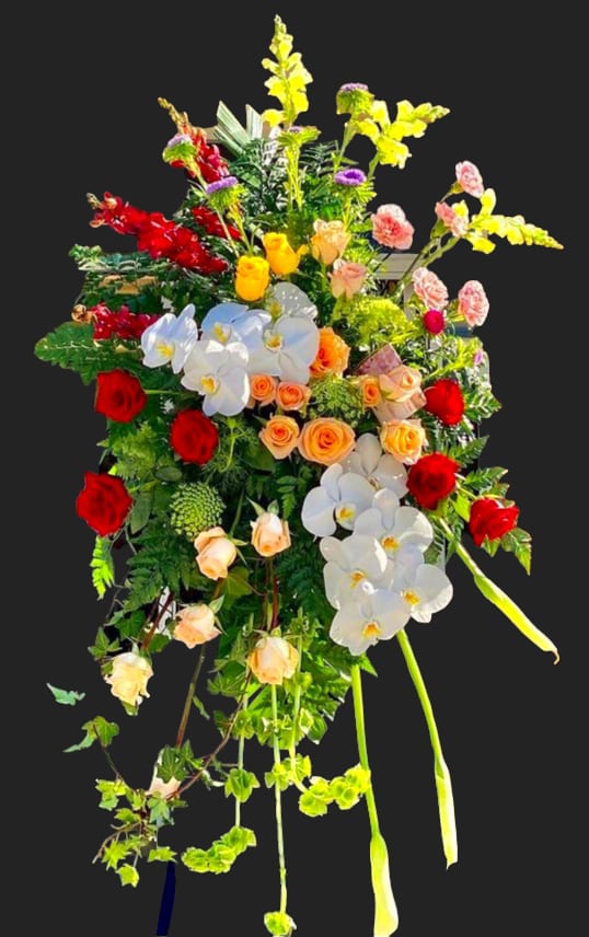 Tall standing floral spray with red, white, yellow, and peach blooms