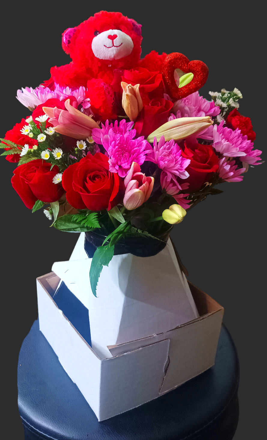 Bouquet of red roses, pink chrysanthemums, and a teddy bear topper