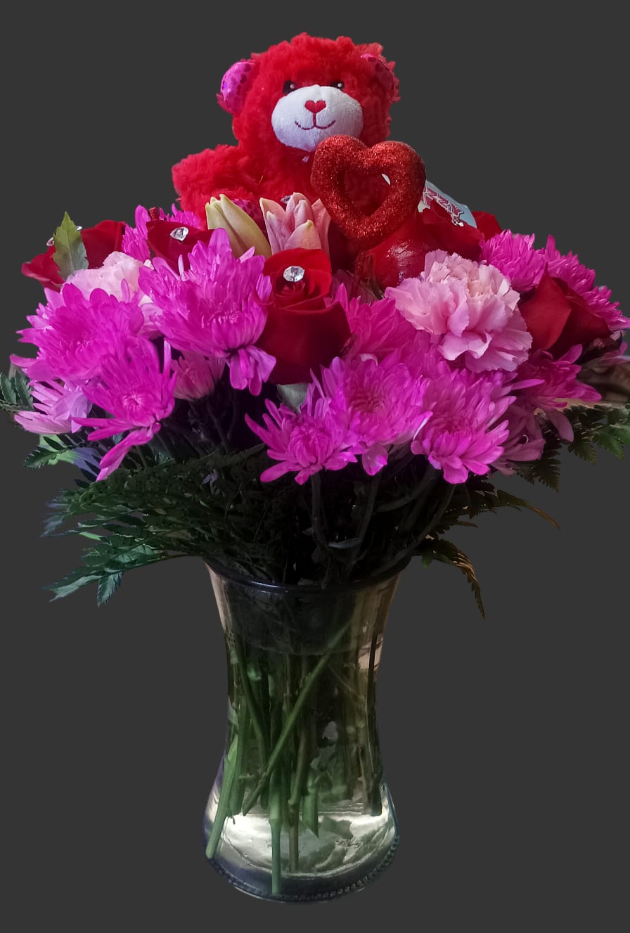 Pink and red bouquet with a teddy bear and heart in a glass vase