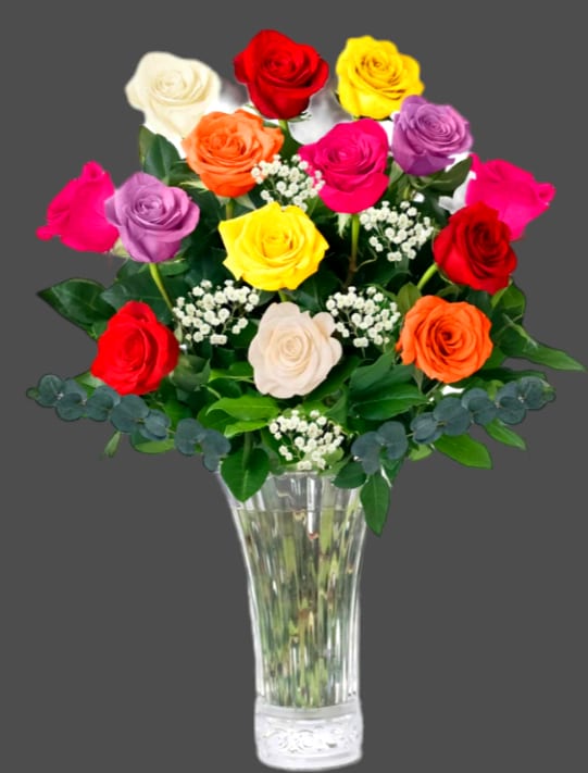 Colorful roses arranged in a clear glass vase