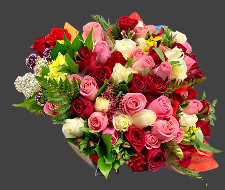Large bouquet of red, pink, and white roses with mixed filler flowers