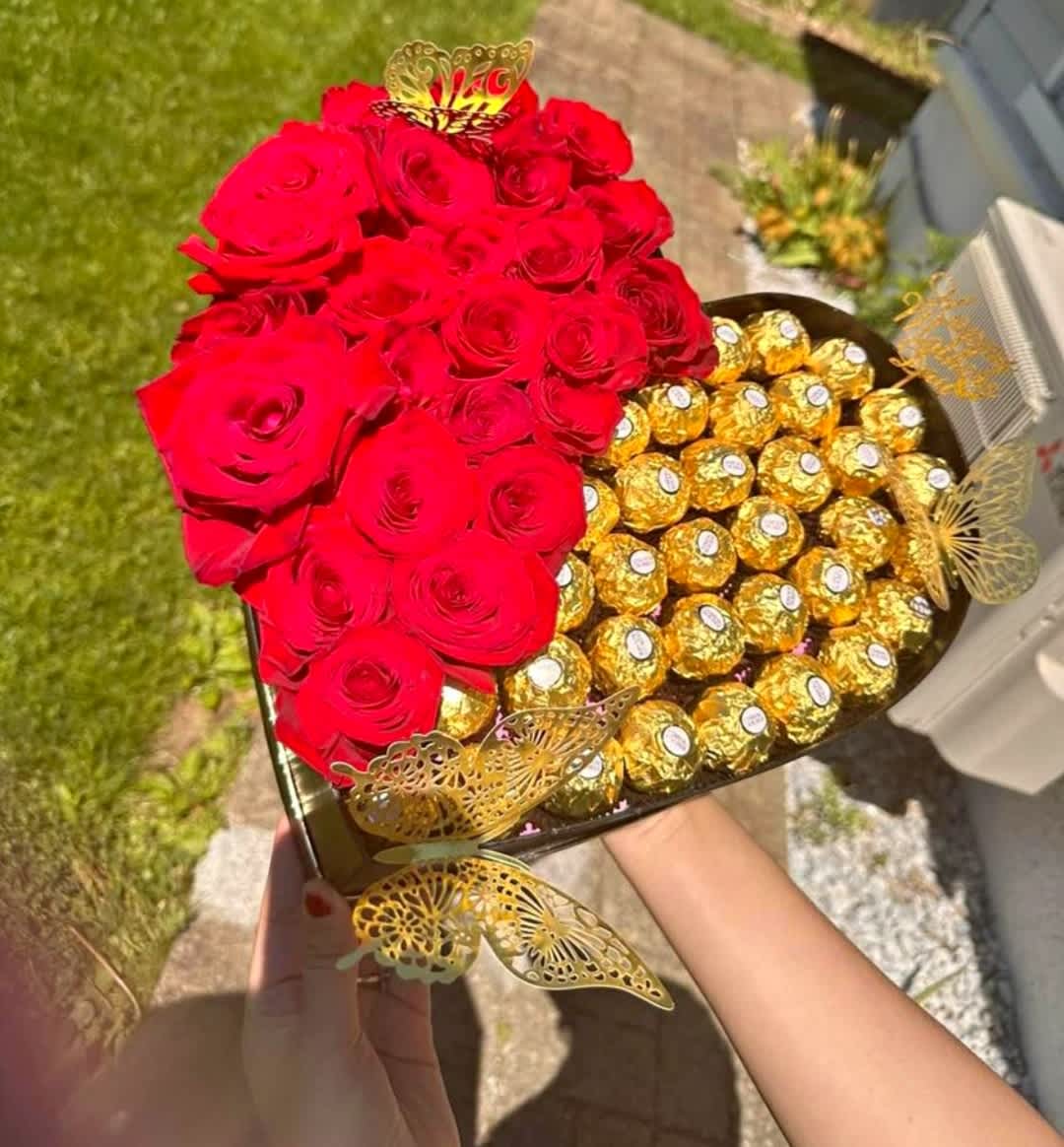 Heart-shaped box with red roses and gold-wrapped chocolates