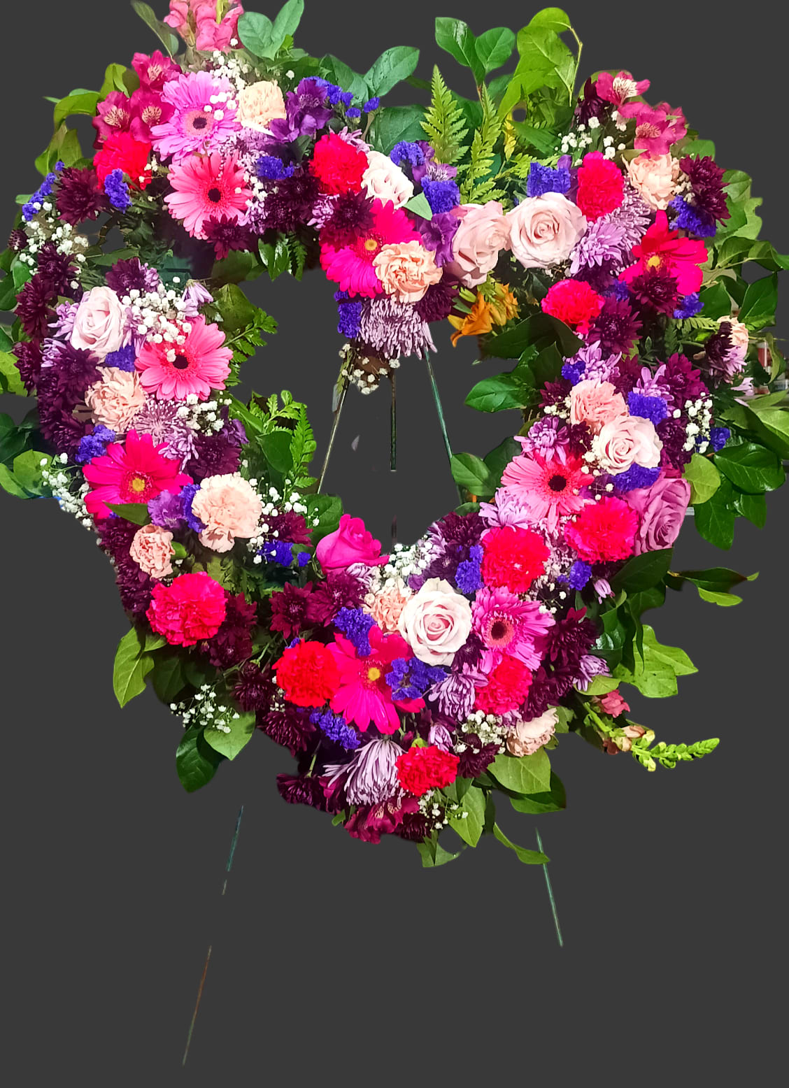 Heart-shaped floral wreath with pink, purple, and white flowers