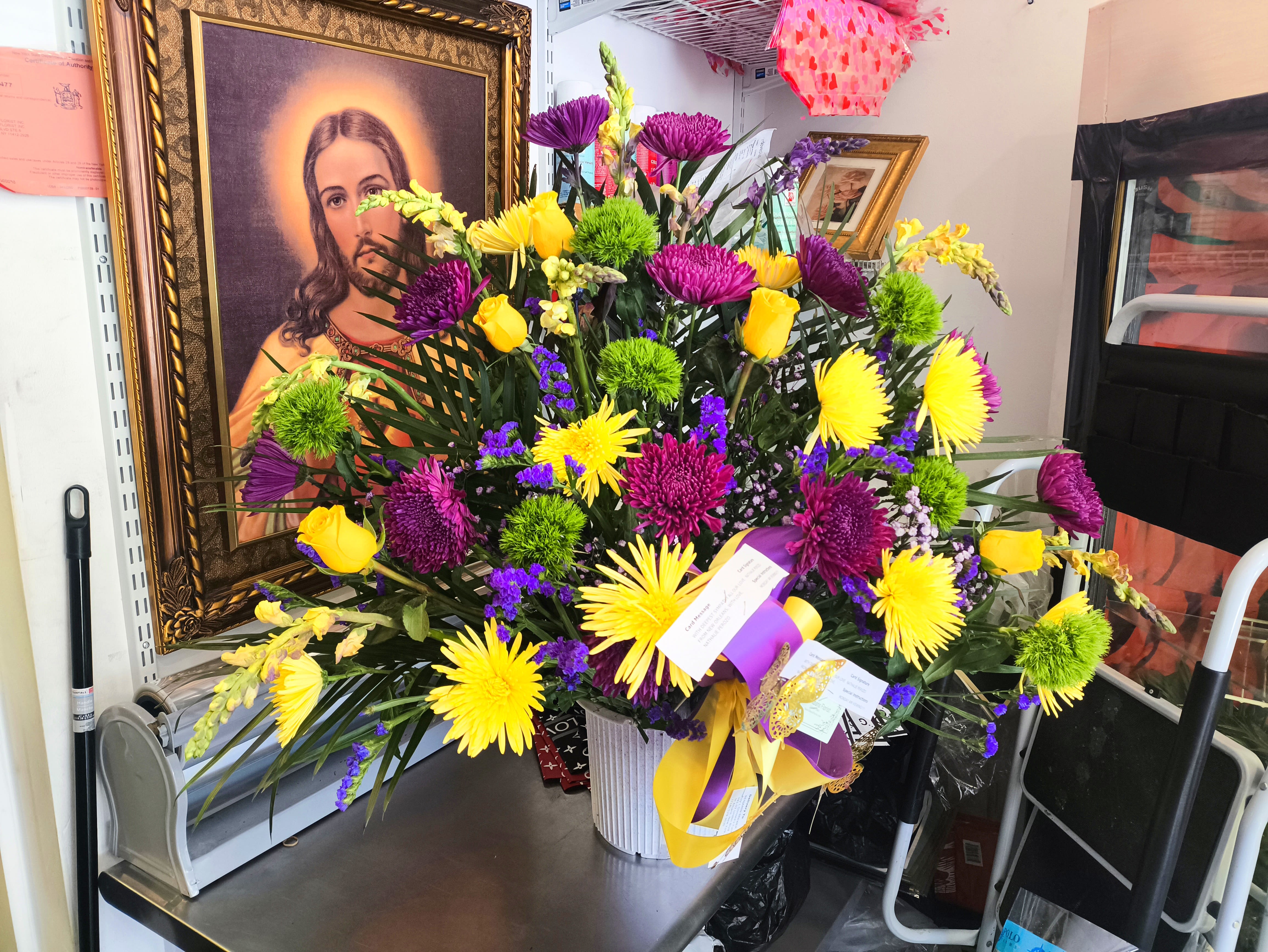 Bright mixed bouquet in a white vase with yellow and purple flowers
