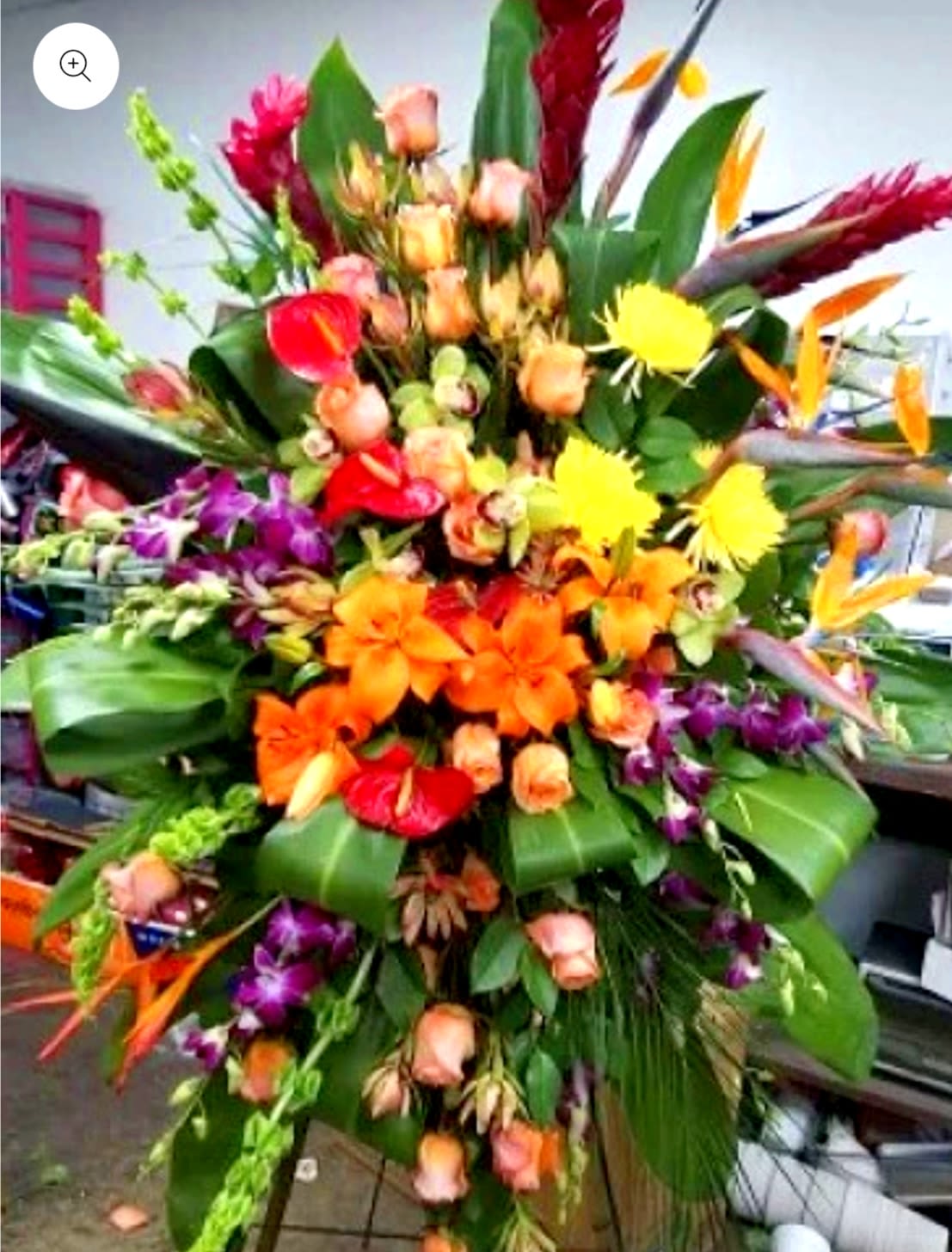 Large tropical floral spray with orange, pink, purple, and yellow blooms