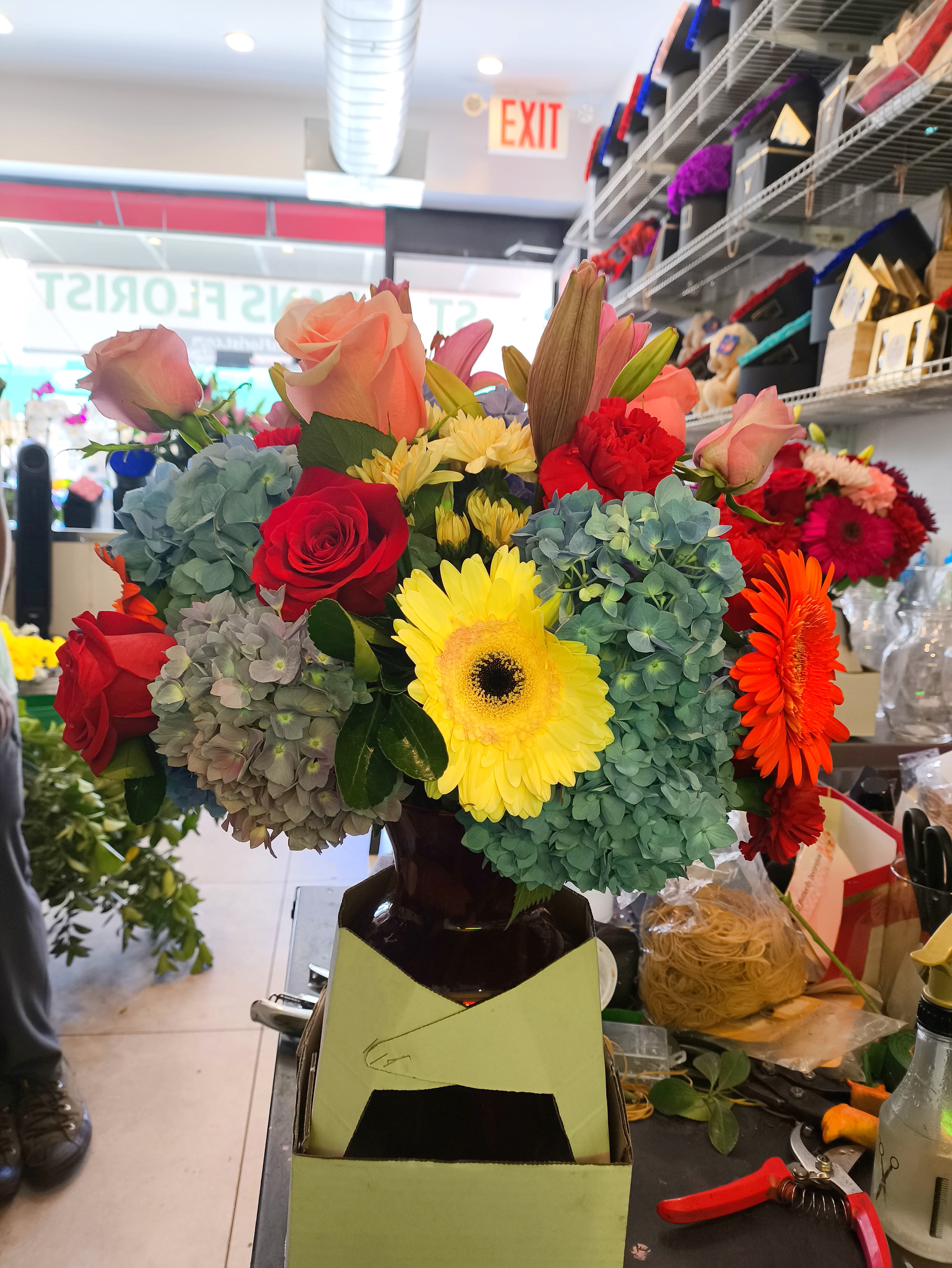 Mixed bouquet of roses, gerbera daisies, and hydrangeas in a vase