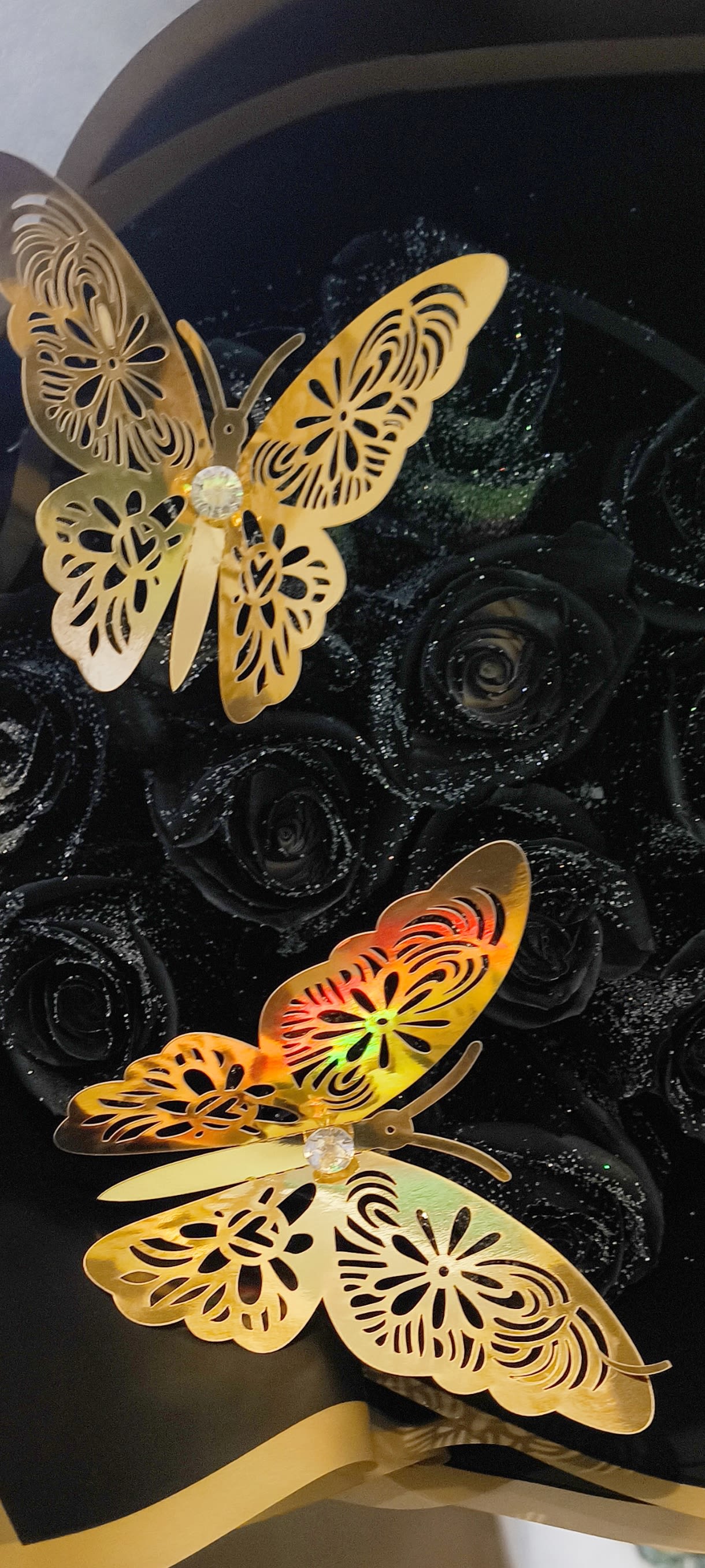 Black rose bouquet with two gold butterfly decorations