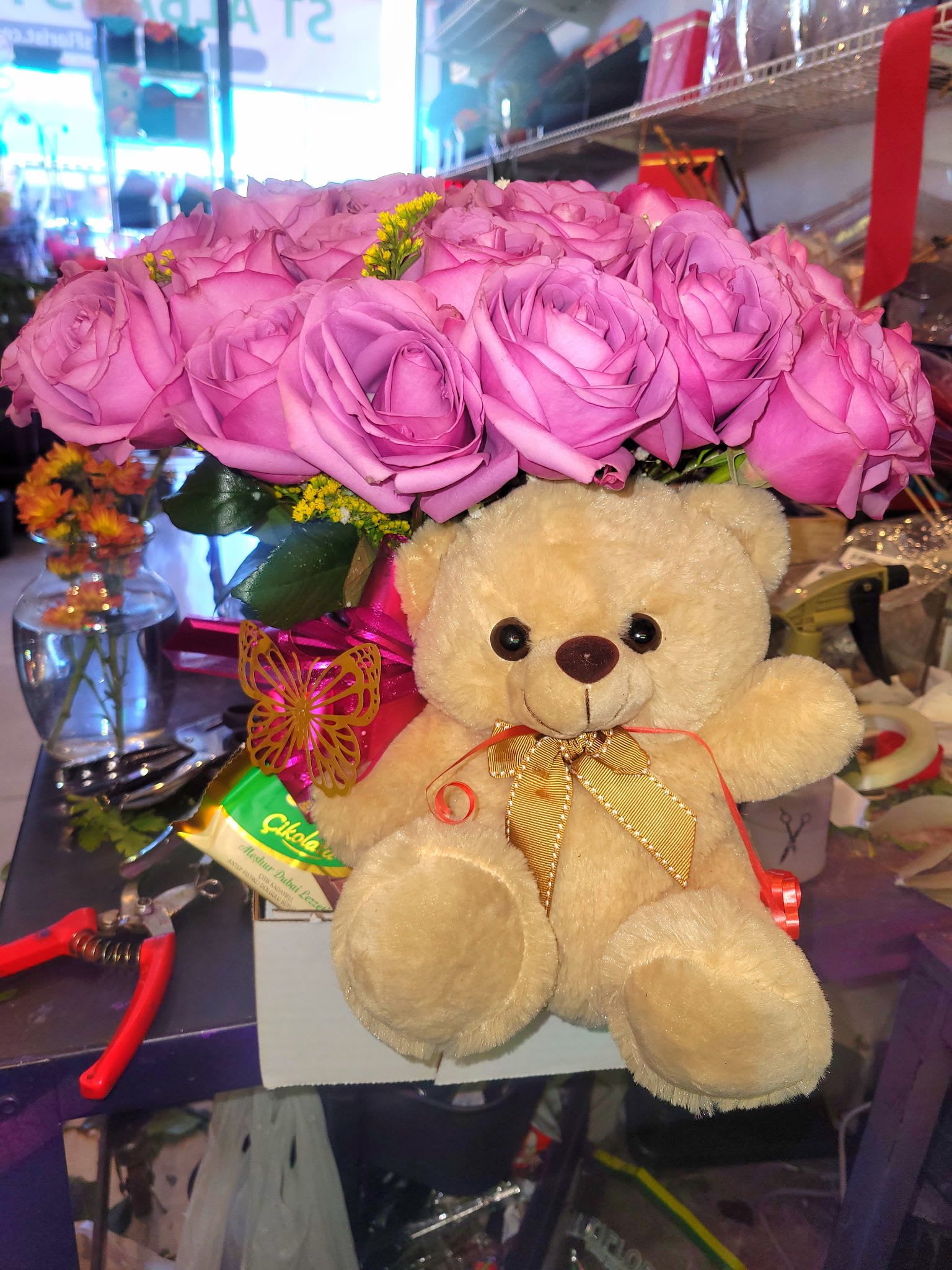 Pink rose bouquet with a teddy bear and ribbon