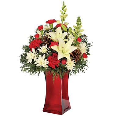 Home For The Holidays Bouquet - Shimmering with delight, that's how everyone on your list will feel when they receive this very special holiday bouquet featuring Asiatic lily, snapdragon, cushion poms, mini carnations, carnations, roses and pine cones in a red gathering vase.