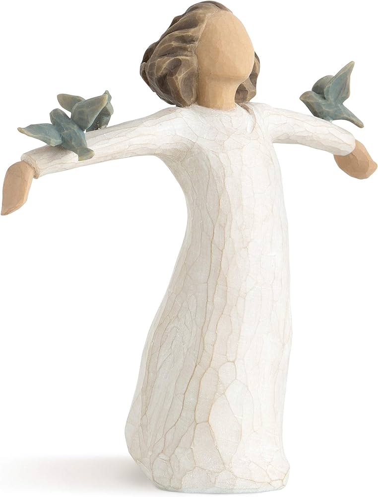 Wooden angel figurine in a white dress with outstretched arms