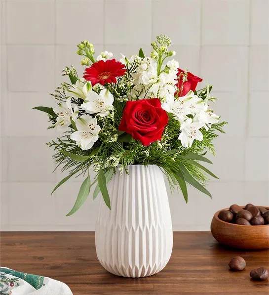 Dazzling Christmas Bouquet - Celebrate the most magical time of year with our dazzling bouquet. A rich gathering of blooms in classic red and white is accented by lush greenery. Hand-designed in our keepsake White Modern Vase, featuring a tapered design and matte finish, it’s a gift that brings the joy of Christmas to family and friends, near and far.