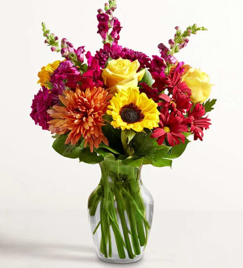 Expressions of Fall - A beautiful tribute to autumn’s beauty. Our colorful gathering of blooms in radiant red, sunny yellow, and rich purple delivers the splendor of the season along with your warmest sentiments.
