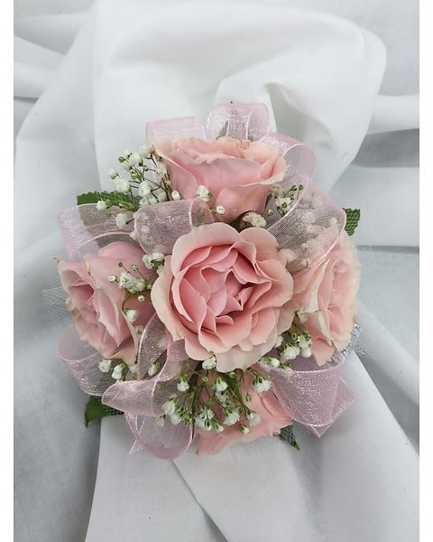 Pink Rose Corsage with Sheer Ribbon - A classic pink corsage hand-tied in pink ribbon that compliments any outfit. A beautiful addition to any prom, homecoming, formal, or wedding event. 