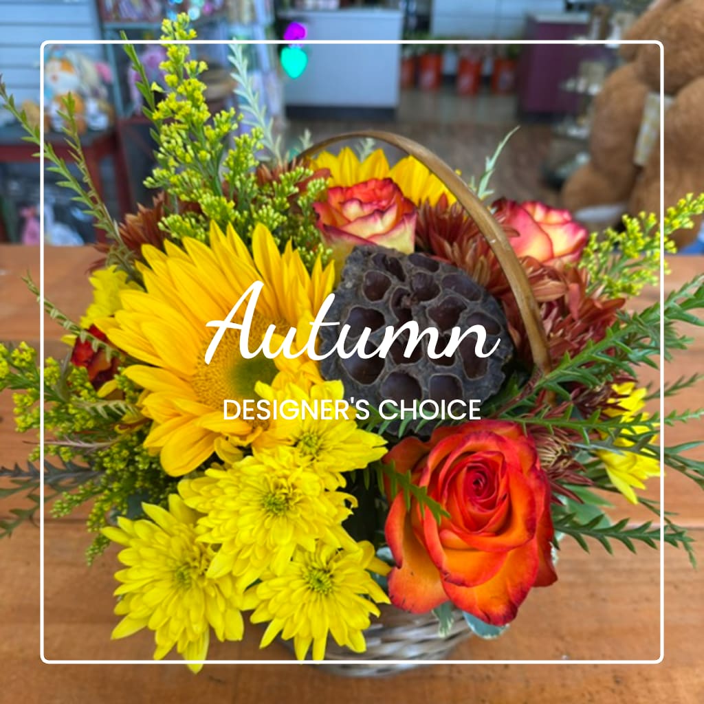 Autumn bouquet with yellow mums, orange roses, and a basket handle