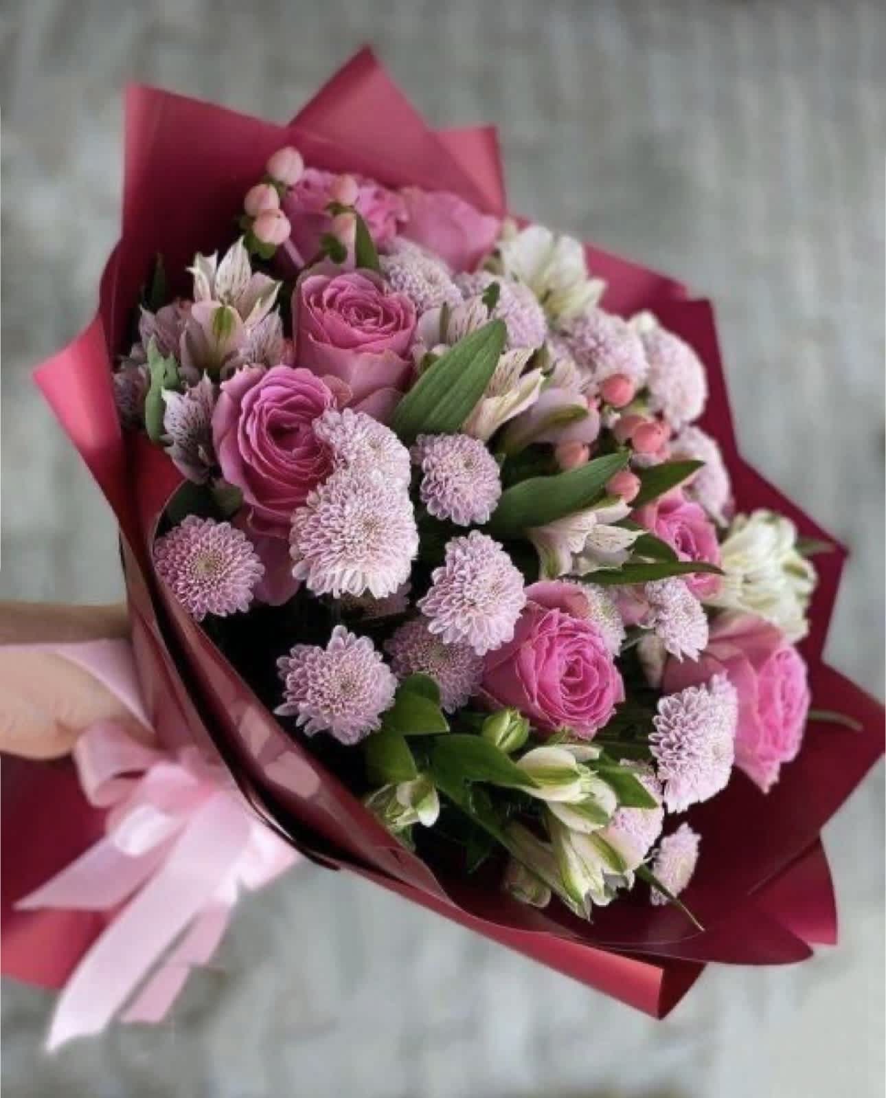 Pink rose and chrysanthemum bouquet wrapped in magenta paper