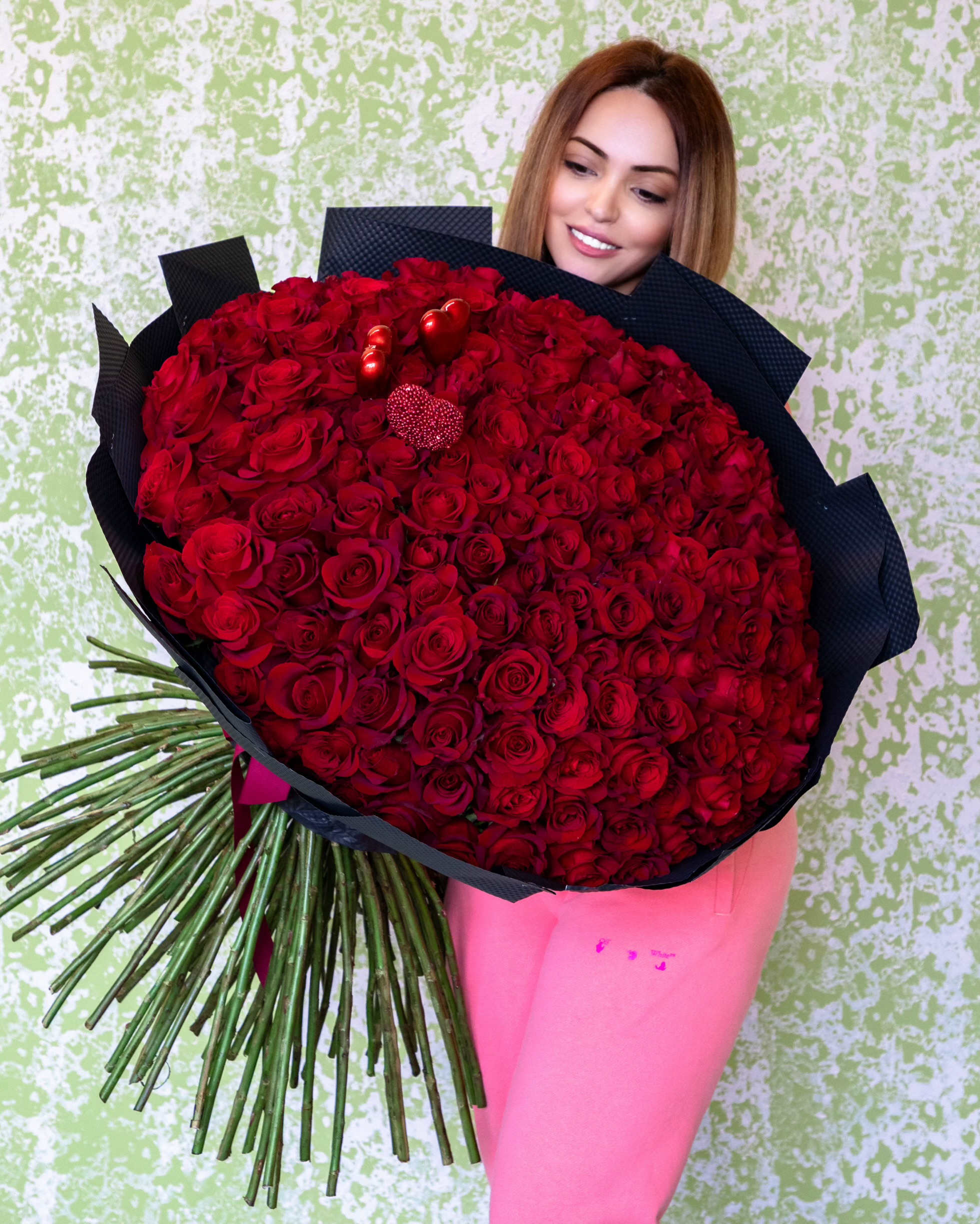 Large bouquet of red roses wrapped in black paper