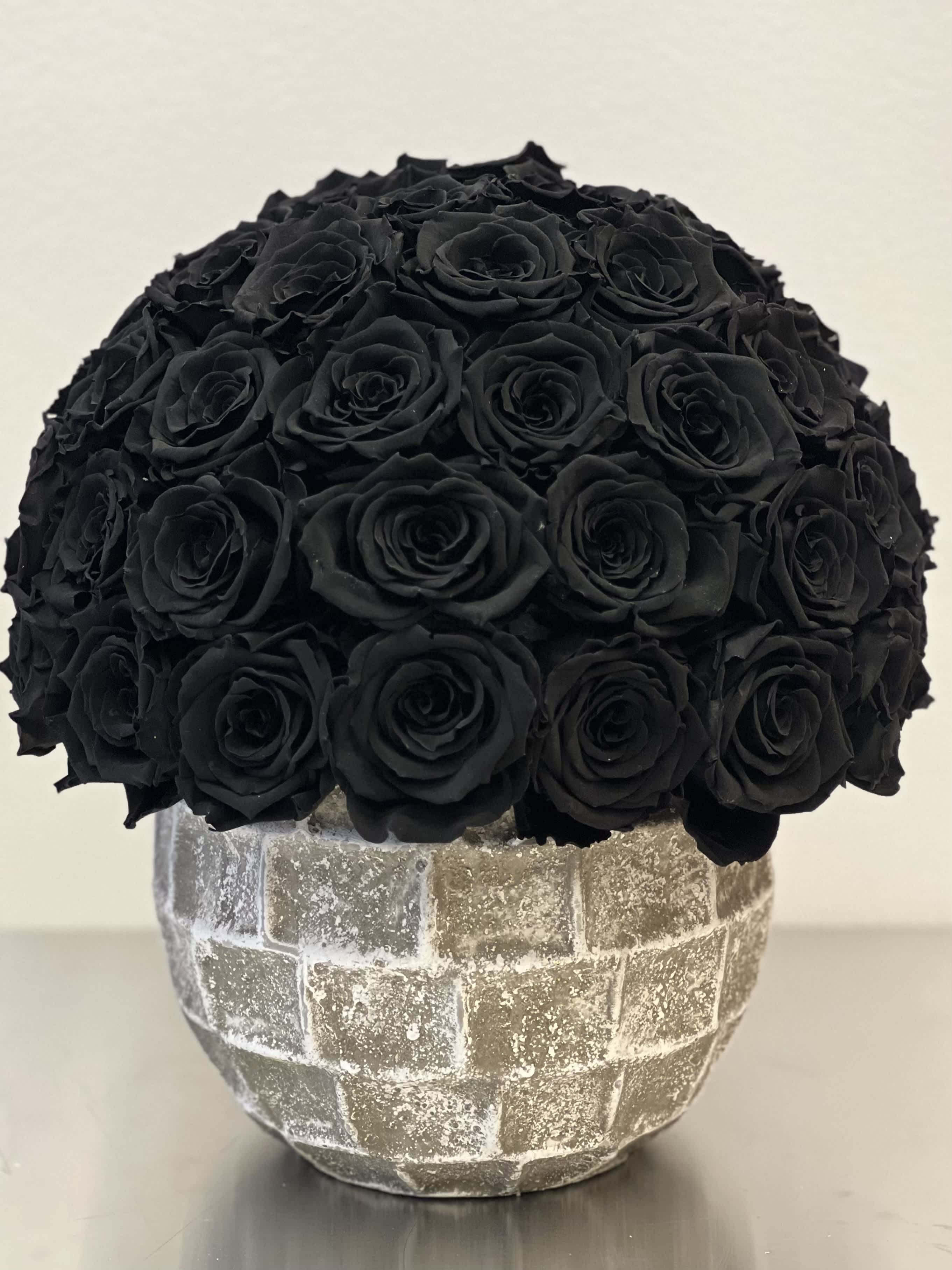 Black rose bouquet in a textured silver vase