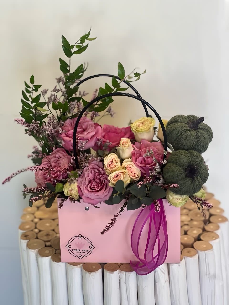 Pink and cream roses in a pink gift box with a ribbon