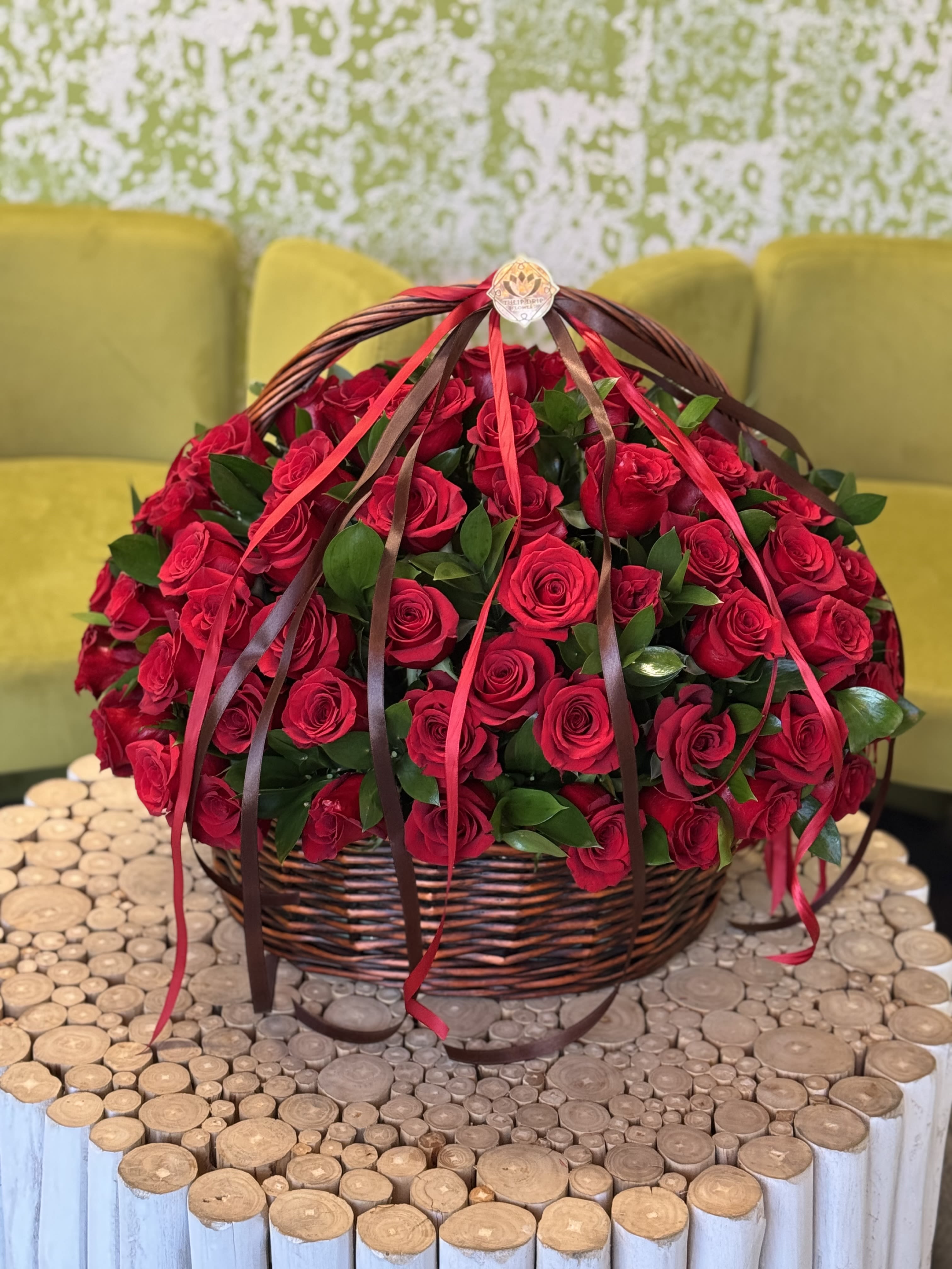 Basket of red roses with ribbon streamers