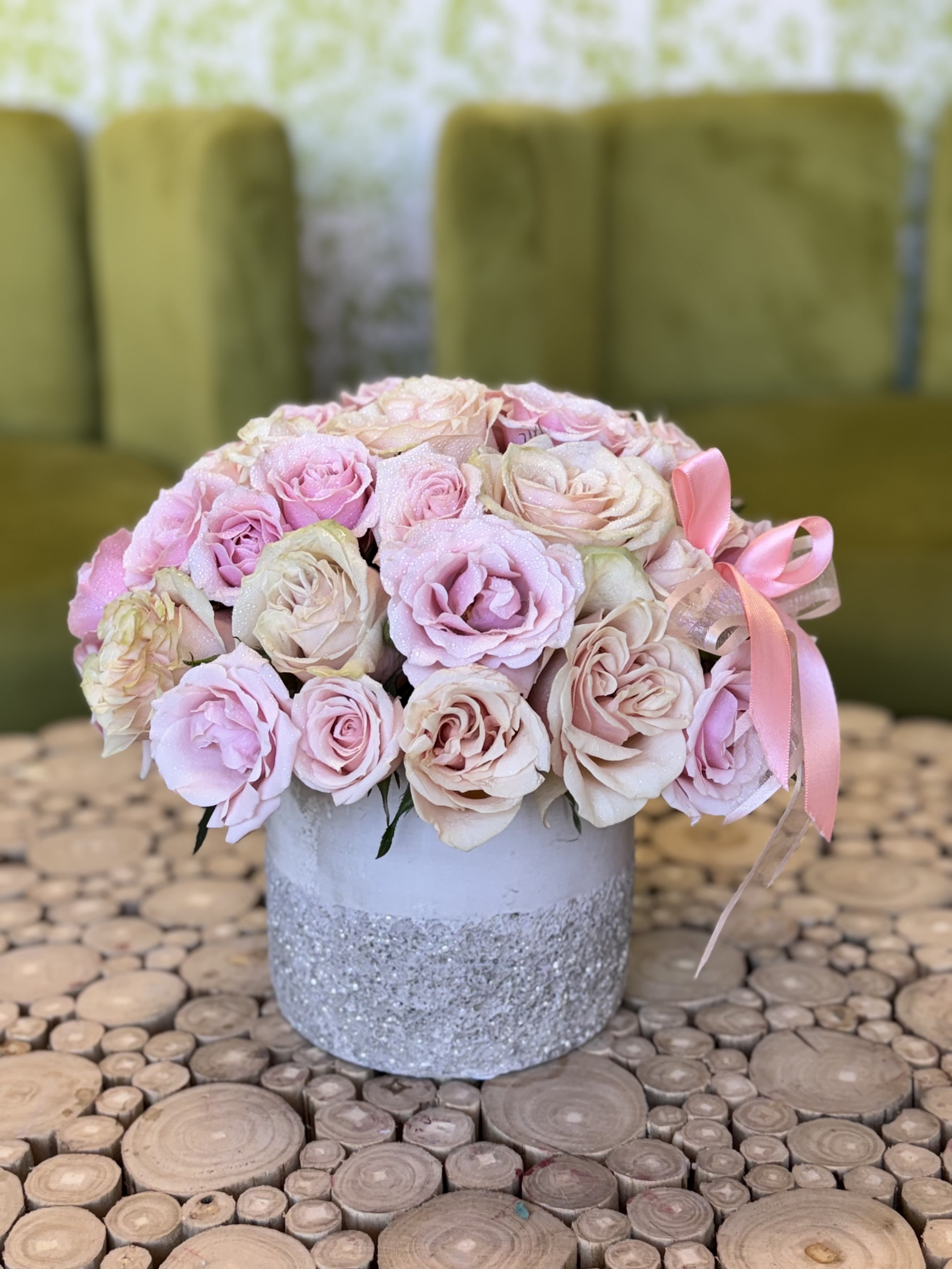 Pink and cream rose bouquet in a glittered silver vase with ribbon